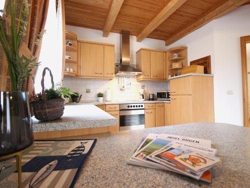 a kitchen with wooden cabinets and a book on a counter at Ferienwohnung Wolfgang in Altenkirchen in Altenkirchen