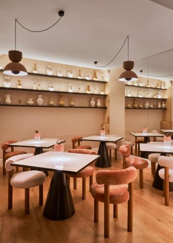 a restaurant with tables and chairs and shelves at Boutique Hotel Posada Terra Santa in Palma de Mallorca