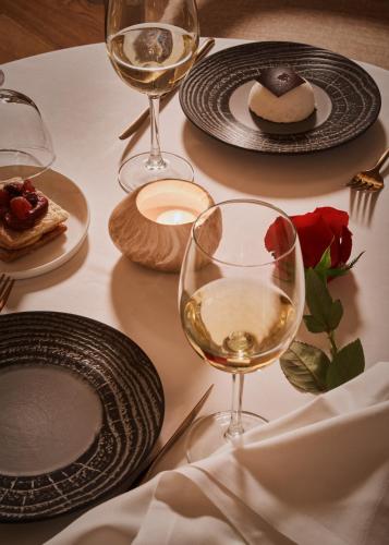 a table with plates and glasses of white wine at Boutique Hotel Posada Terra Santa in Palma de Mallorca