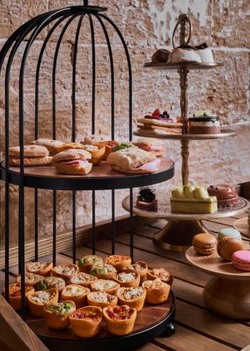 a display of different types of pastries and cakes at Boutique Hotel Posada Terra Santa in Palma de Mallorca