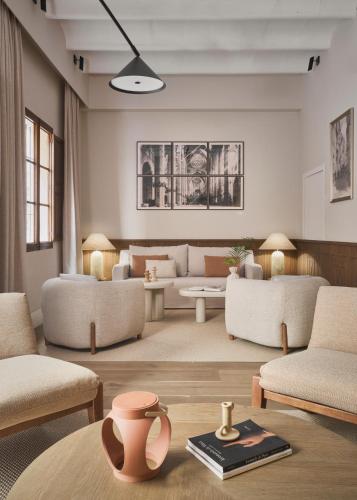 a living room with couches and a table at Boutique Hotel Posada Terra Santa in Palma de Mallorca