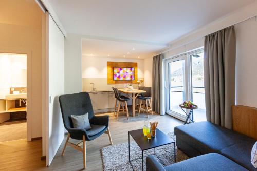 a living room with a couch and a table at Seehaus Winkler in Weissensee