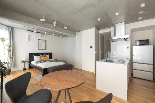 a room with a kitchen and a table and a bed at Dash Living Kagurazaka in Tokyo
