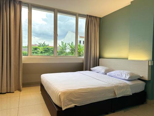 a bedroom with a bed with a large window at De UPTOWN Hotel @ P.J. 222 in Petaling Jaya