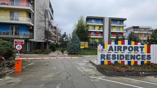 a sign in a parking lot in front of a building at Airport Residence in Otopeni