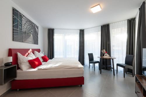 a bedroom with a bed and a table and chairs at Grazora Living Apartments in Graz