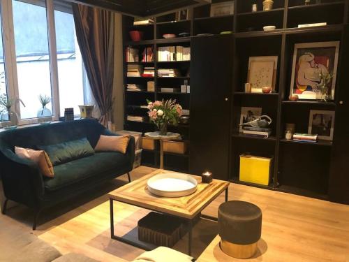 a living room with a couch and a coffee table at Charming flat near Bois de Boulogne Paris in Neuilly-sur-Seine