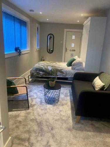 a living room with a bed and a couch at Teviot View in Hawick