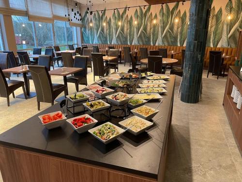 a buffet of food on a table in a restaurant at Hotel Victor Pruszków DeSilva in Pruszków