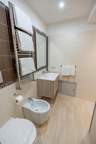 a white bathroom with a sink and a toilet at Il Paradiso sul Mare Apartment in Scala