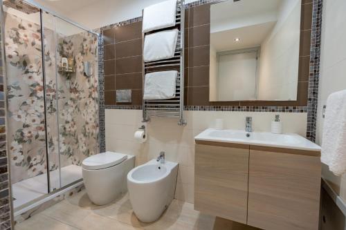 a bathroom with a toilet and a sink and a shower at Il Paradiso sul Mare Apartment in Scala