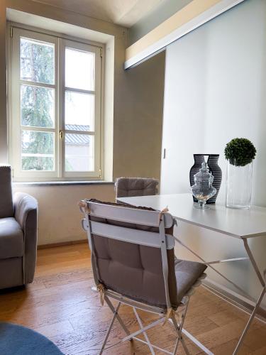 a dining room with a table and a chair at ComeCasa San Secondo White in Asti