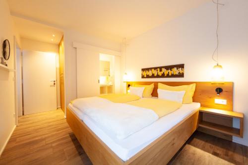 a bedroom with a large white bed in a room at Seehaus Winkler in Weissensee