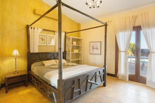 a bedroom with a canopy bed in a room at Villa Masé Fuerteventura in La Asomada