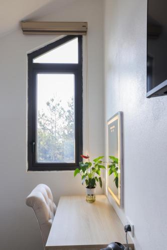 a dining room with a table and a window at Cong Fu Hotel in Bắc Hà