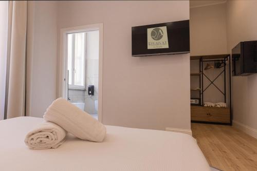 una camera da letto con un letto e un asciugamano sopra di Relais At Via Veneto a Roma