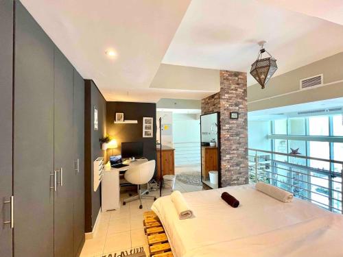 sypialnia z łóżkiem i biurkiem w pokoju w obiekcie City Haven 1br Loft Remote Work, Projector Tv w Dubaju