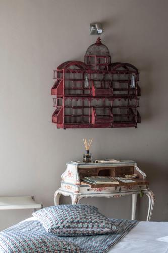 a bedroom with a bird cage on the wall at Relais Le Due Matote in Bossolasco