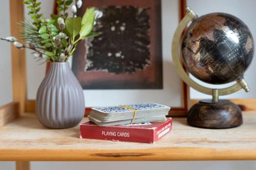 a table with two books and a vase and a globe at Ski Hut Smučka in Kranjska Gora