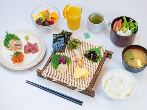 una mesa cubierta con platos de comida y bebida en ibis Styles Kyoto Station, en Kioto