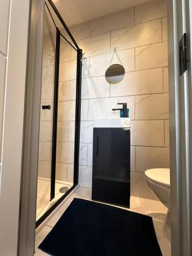 a bathroom with a shower and a toilet and a sink at Serviced Ensuite Double Room - Near Greenwich Park - The O2 Arena - Nearby Transport Links to Central London - New Cross Station - Lewisham SE14 in London