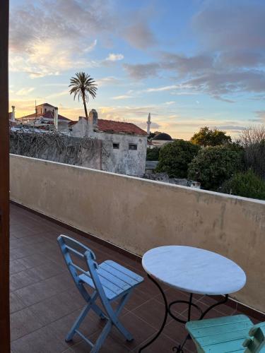 a patio with a table and chairs on a balcony at VILLA VICTORIA OLD TOWN in Rhodes Town