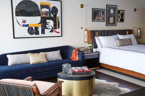 a living room with a bed and a couch at Thompson Dallas, by Hyatt in Dallas