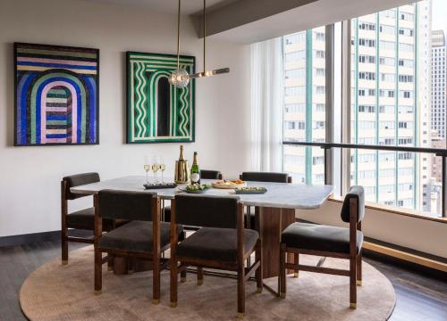 a dining room with a table and chairs at Thompson Dallas, by Hyatt in Dallas