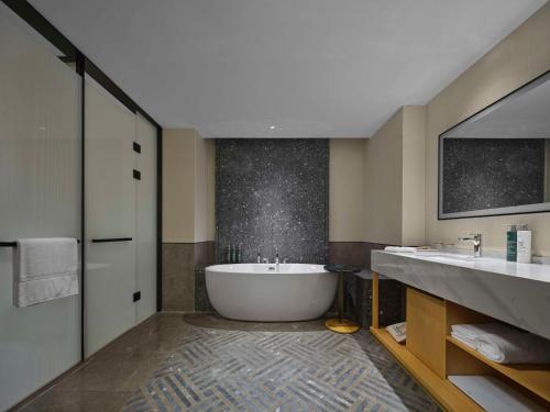 a large bathroom with a tub and two sinks at Hilton Garden Inn Guilin Yangshuo in Guilin