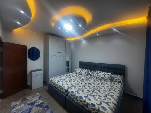 a bedroom with a bed and lights on the ceiling at Bright CityStars in Cairo