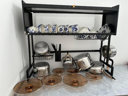 a shelf with plates and other items on it at Mộc Lâm Homestay in Phú Quốc
