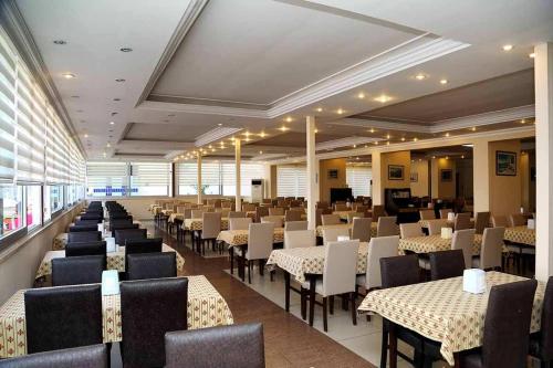 a dining room with tables and chairs in a building at CLUB BAYAR BEACH HOTEL in Alanya