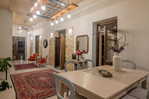 a dining room with a table and chairs at CARPE DIEM HOTEL in Archanes