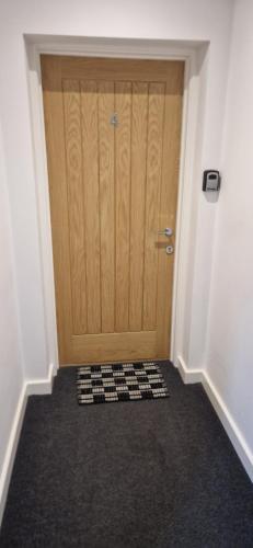 a door with a checkered floor in front of it at No 4 Hawthorn Ground floor apartment in York