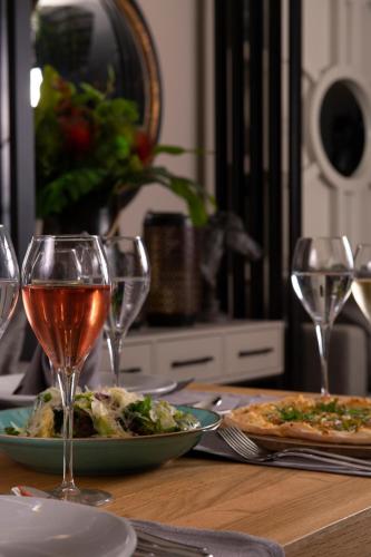 a table with two plates of food and wine glasses at Miramare Beach Hotel - Ultra All Inclusive in Side