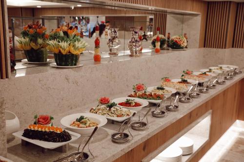 a buffet line with many plates of food at Miramare Beach Hotel - Ultra All Inclusive in Side