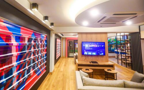 a living room with a tv and a large screen at Miramare Beach Hotel - Ultra All Inclusive in Side