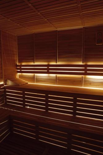 a row of wooden benches in a room with lights at Miramare Beach Hotel - Ultra All Inclusive in Side