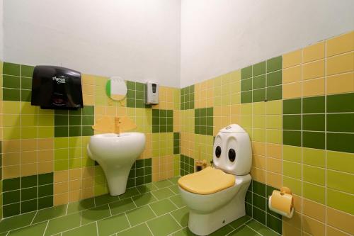 a bathroom with a toilet with a face drawn on it at Miramare Beach Hotel - Ultra All Inclusive in Side