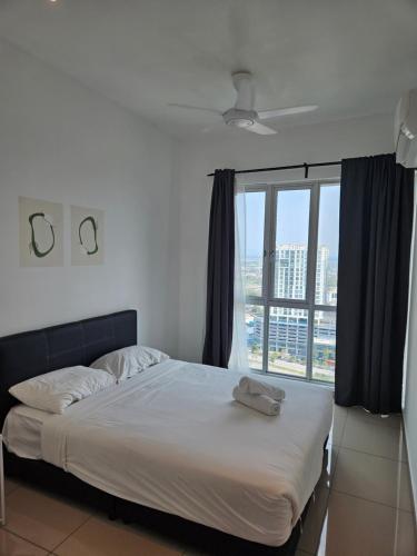 a bed in a room with a large window at Metropol Serviced Apartment Bukit Mertajam Perda in Bukit Mertajam