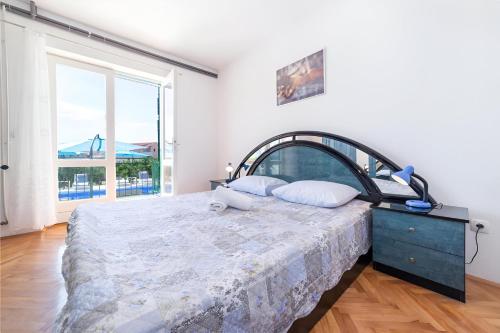 a bedroom with a bed and a large window at NEW! Apartments with shared pool, Vodice in Vodice