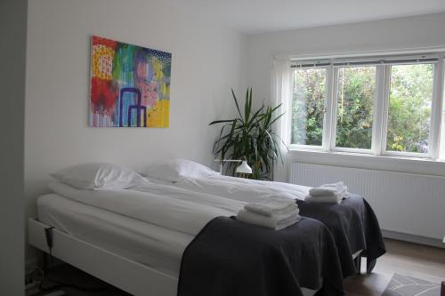 a white bedroom with a bed with towels on it at Bed and Breakfast i Gelsted in Gelsted