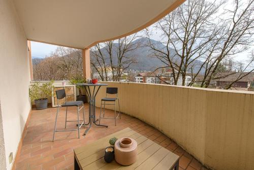 a patio with a table and chairs on a balcony at Les Terrasses Montfleury, aux portes d'Annecy- Une exclusivité LLA Selections by Location lac Annecy in Annecy