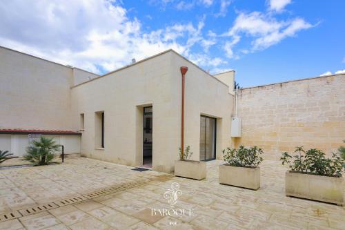 a large white building with plants in front of it at Baroque B&B in Lecce