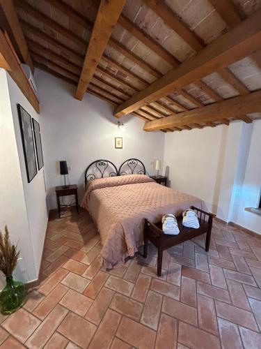 a bedroom with a bed and a table at Al Castello in Tavullia