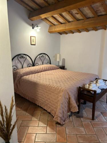 a bedroom with a large bed and a table at Al Castello in Tavullia
