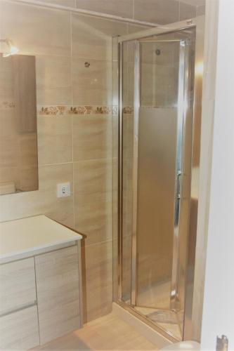 a shower with a glass door in a bathroom at Can Jané Port d Alcudia in Port d'Alcudia