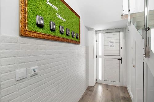 a hallway with a white brick wall with phones on it at The Greey's House A in Telde