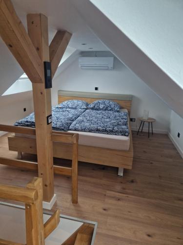 a bedroom with a bed in a attic at Ferienhäuschen Landleben pur in Much