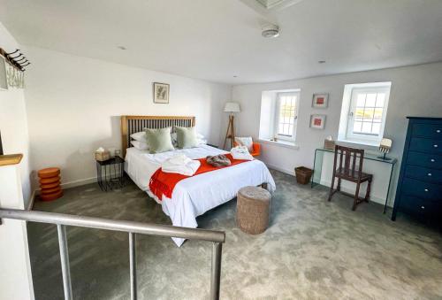a bedroom with a bed with a red blanket at Studio House in St Margaret's Hope
